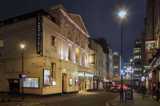 Side view of Harold Pinter Theatre at night