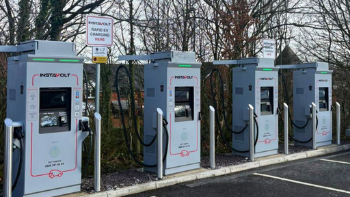 Row of InstaVolt ultra-rapid EV charging stations at Exeter M5 McDonalds, located on Russell Way, with dedicated parking bays and easy access for drivers.