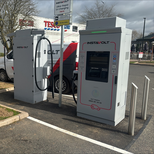 InstaVolt ultra rapid EV charging units located in the car park at Weston Favell Shopping Centre, with Tesco Extra visible nearby in Northampton.