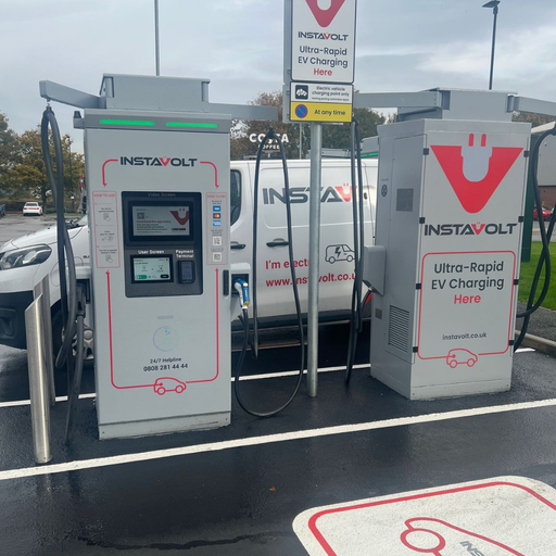 A detailed view of two InstaVolt chargers with clear signage and a branded van in the background, located in the car park of McDonald’s Denaby Main. Costa Coffee signage is faintly visible, highlighting local amenities.