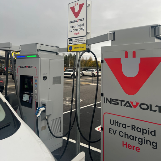 A charger in use with a van connected, showcasing the InstaVolt ultra-rapid EV charger and overhead signage at McDonald’s on Doncaster Road. Other vehicles and McDonald’s arches are visible in the background.