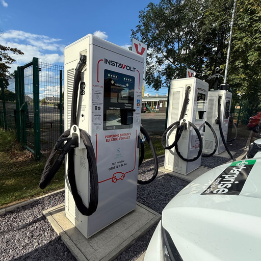 Side view of InstaVolt ultra-rapid chargers at Mile House with several units available for use.