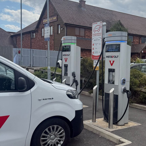 Two InstaVolt rapid chargers are in use outside Dearne Valley Farm. An electric van is plugged in, highlighting the convenience of charging while dining.