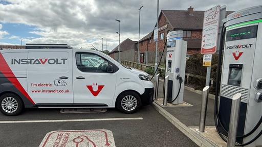 An InstaVolt-branded electric van is charging outside Dearne Valley Farm. Clear bay markings and signage indicate dedicated EV charging spaces.