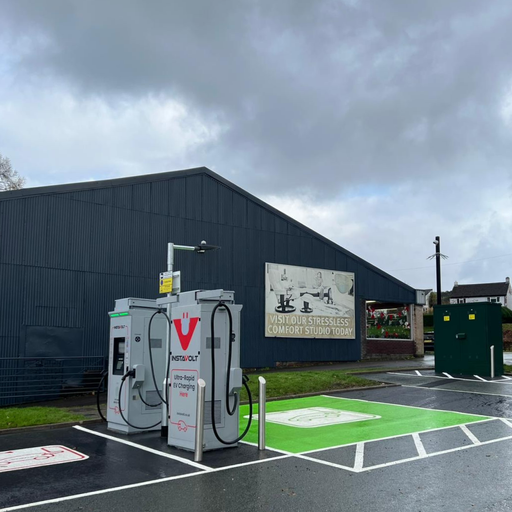 Ultra-rapid InstaVolt EV chargers installed near Hafren Furnishers at Llanidloes, offering easy access and designated green parking bays.