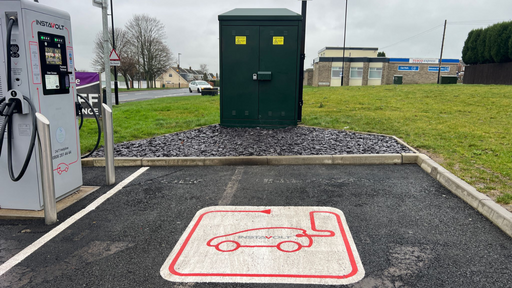InstaVolt rapid electric vehicle chargers with marked bays and visible signage at Chapel House Service Station, Newcastle upon Tyne.