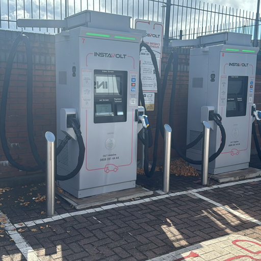 This close-up shot highlights two InstaVolt ultra-rapid electric vehicle chargers with user-friendly displays and dual charging cables, located at Apex Retail Park, Birmingham.