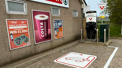 EV charging at Strathbogie Filling Station on the A96 in Huntly, featuring InstaVolt rapid charger alongside a SPAR store, Costa Express, and full service station amenities.