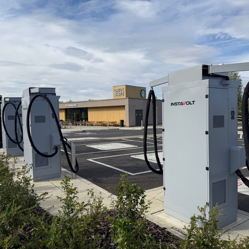 Close-up of InstaVolt EV chargers with Starbucks drive thru in view at Kempston charging site.