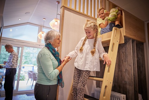 Grandparents relax in a Forest Pod with their grandchildren