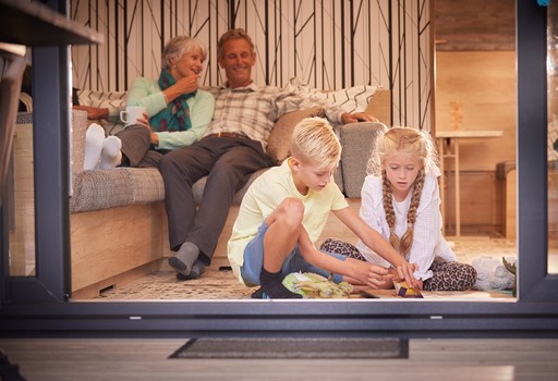 Grandparents relax in a Forest Pod with their grandchildren