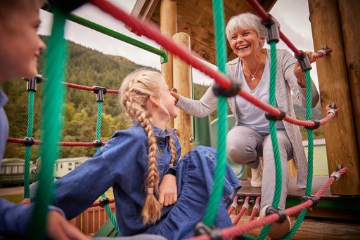 Grandparents play with their grandchildren in the outdoor play area at Stratheck