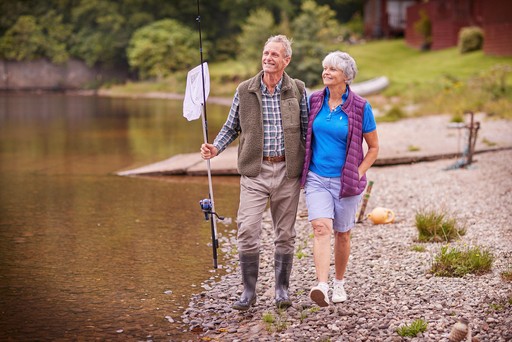 Retired couple stroll along the banks of Lock Eck in search of the perfect location to fish.