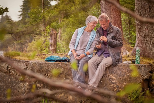 Retired couple take a walk through the surrounding woodlands of Stratheck Holiday Park