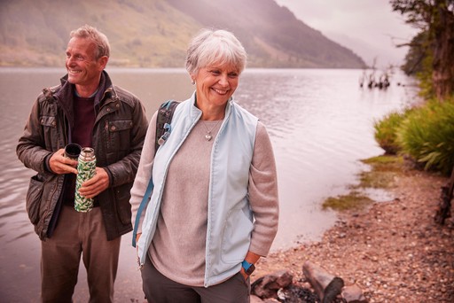 Retired couple stroll along the banks of Loch Eck at Stratheck