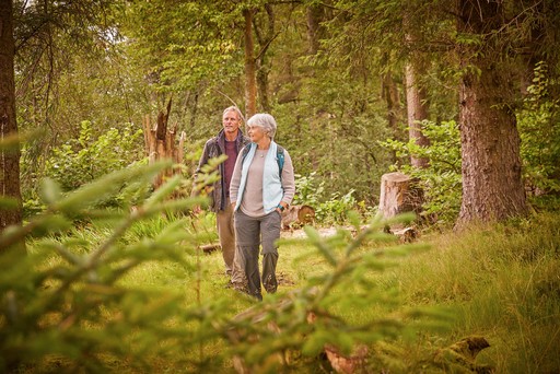 Retired couple take a walk through the surrounding woodlands of Stratheck Holiday Park