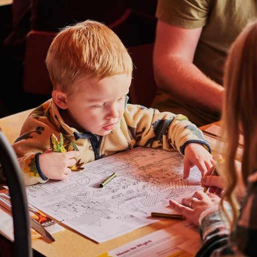 Young Brightside customer with activity sheet and crayons