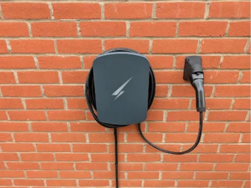 EV charger unit installed on a red brick exterior wall in Bedfordshire by Holden Electrical, OZEV-approved EV charger installation Bedford