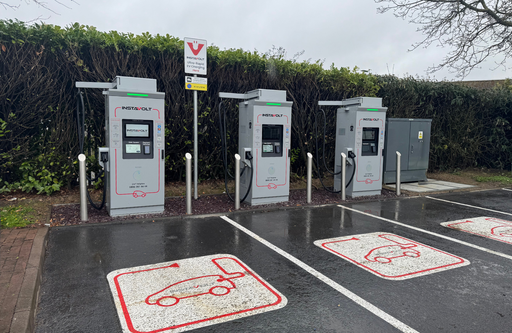 Front view of multiple InstaVolt chargers with clearly marked EV parking bays in McDonald’s car park