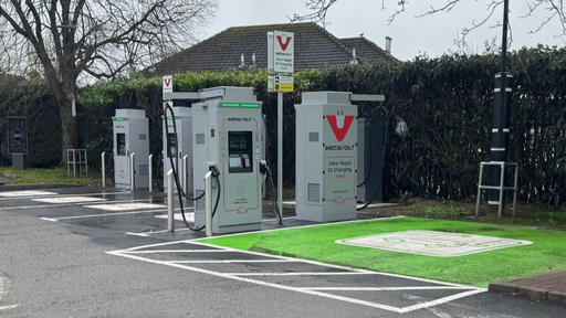 Wide view of InstaVolt ultra-rapid chargers in McDonald’s car park with marked EV bay and surrounding parking area