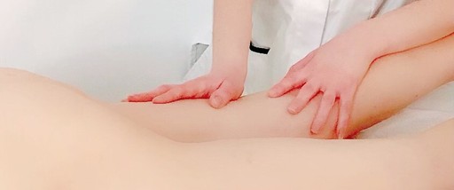 Hands massaging a naked body