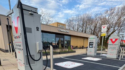 InstaVolt ultra-rapid charging bays in front of Starbucks on Port Road, Newport, with outdoor seating and drive thru access visible.