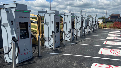 Freshly marked InstaVolt charging bays under clear skies, with multiple ultra-rapid chargers ready for incoming EV drivers.