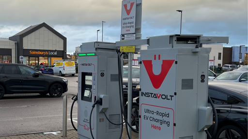 This image shows InstaVolt ultra-rapid electric vehicle chargers located at Berryfields Local Centre in Aylesbury. Sainsbury’s Local is clearly visible in the background, highlighting the convenience of nearby retail amenities for EV drivers.