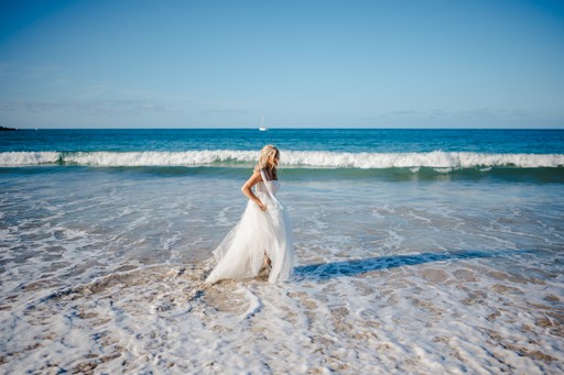 Bride taking a dip in the sea in Cornwall