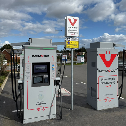 Detailed view of InstaVolt charging unit and sign showing ultra-rapid EV charging at Tesco Express location
