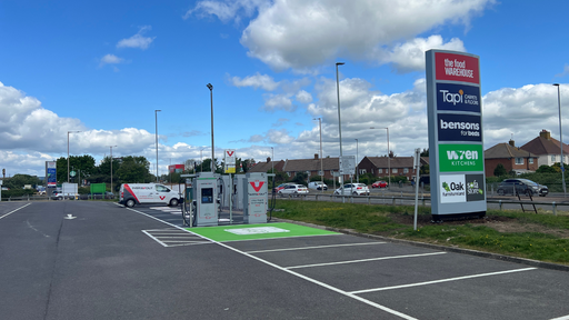 Wide view of InstaVolt EV charging bays at Lottbridge Drove Retail Park with nearby retail stores and easy road access in Eastbourne.