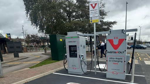 A pair of InstaVolt chargers positioned beside a pedestrian path and parking bays in Kirkby, close to McDonald’s and local amenities.
