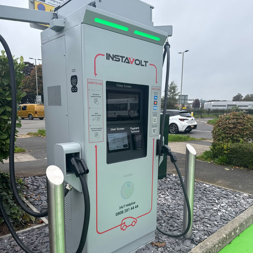 A detailed view of the InstaVolt ultra-rapid charger at Exe Valley Leisure Centre, Tiverton, highlighting the user-friendly touchscreen, payment options, and CCS connector.