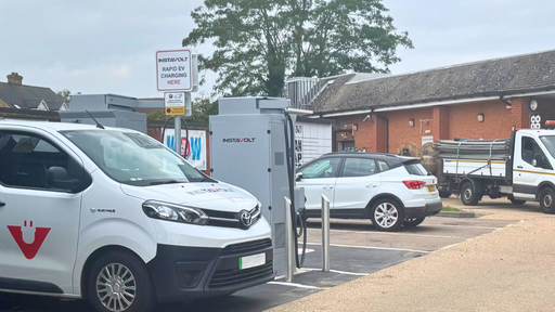 The image shows InstaVolt ultra-rapid chargers in operation outside the Co-op store on Bedford Road, Barton-le-Clay. Multiple vehicles, including an InstaVolt van, are parked and charging.