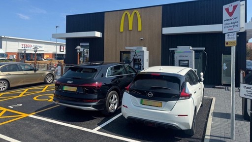 Electric cars using InstaVolt chargers outside a McDonald’s, with Tesco Express across the car park.