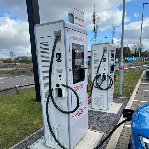 Close-up of two InstaVolt ultra rapid chargers at Leathermill Lane, Rugeley, with one charger in use and clear signage visible.