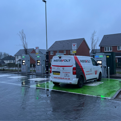 InstaVolt EV charging bays at Co-op Cannock featuring ultra-rapid chargers, marked parking spaces and residential homes behind the site.