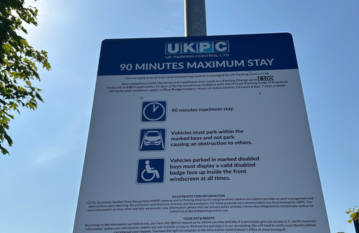 Parking information sign at the InstaVolt ultra rapid EV charging station on Almond Road, Leicester, outlining the site parking terms and maximum stay for customers.