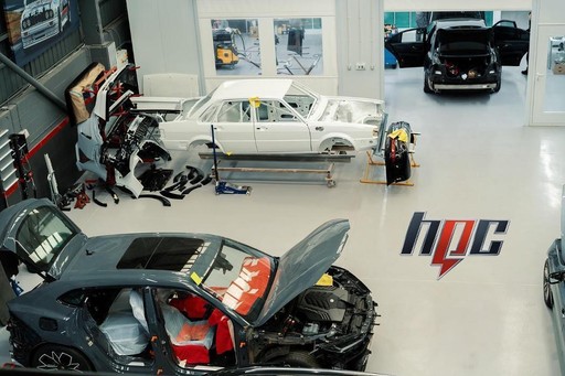 Professional auto body repair shop operations - Skilled mechanics performing collision damage repairs and vehicle restoration using industry-standard techniques and tools