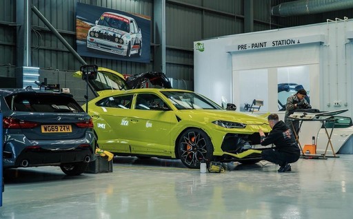 Vehicle damage assessment and restoration planning - High Performance Centre technicians inspecting accident-damaged cars to determine repair scope and restoration timeline