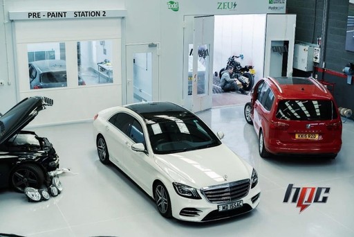 Vehicle in collision repair bay showcasing accident damage restoration - High Performance Centre facility demonstrating professional car accident repair capability and advanced workshop equipment