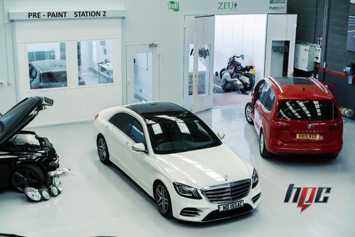 Damaged vehicle ready for collision repair assessment - Auto body shop intake and inspection of accident-damaged cars for comprehensive restoration planning and estimation