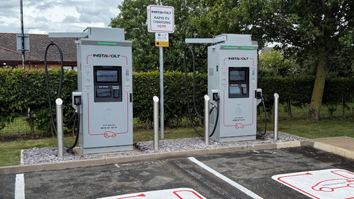 Twin InstaVolt rapid chargers with dedicated bays in a tidy, well-kept roadside stop.