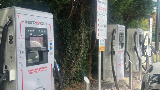 A row of InstaVolt ultra-rapid chargers located at Keypoint on the A34 Northbound near Stone. The charging units are neatly aligned with dedicated EV bays and surrounded by greenery, providing a convenient and accessible stop for electric vehicle drivers.