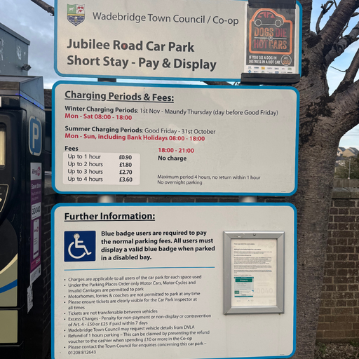 Jubilee Road Car Park sign with detailed information on charging periods, parking fees, Blue Badge requirements, and general rules.