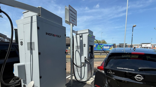 Nissan Leaf charging at InstaVolt ultra-rapid EV station in Stockton-on-Tees retail park with clear signage and modern infrastructure.