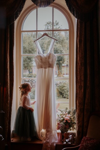 Flower girl looking a wedding dress New House Farm
