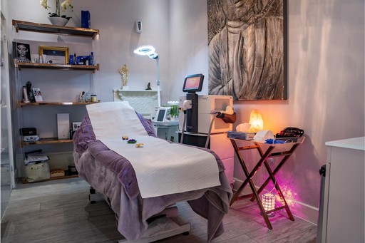 Luxurious aesthetic treatment room at The Harrogate Clinic featuring a comfortable treatment bed, advanced laser equipment, ambient lighting, and elegant décor for skin rejuvenation and cosmetic procedures in Harrogate.