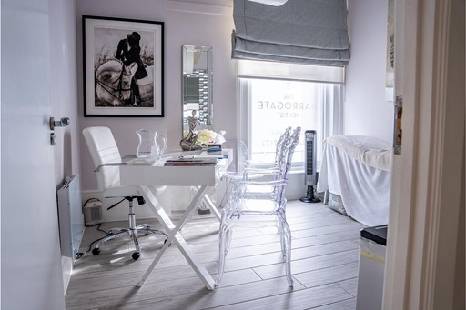 Elegant private consultation room at The Harrogate Clinic with a stylish desk, designer seating, and natural light, where patients discuss treatment plans with the clinic's dental and aesthetic specialists in Harrogate.