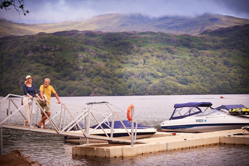 Couple stand on the jetty at Loch Lomond